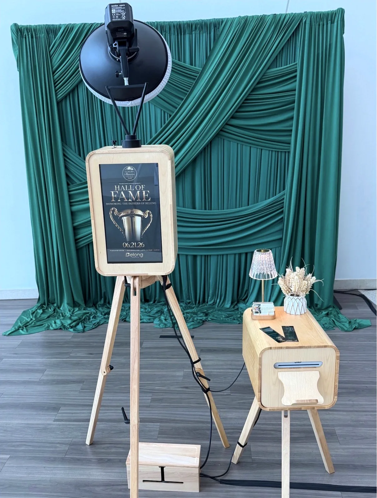 Photo booth in front of emerald green drapery