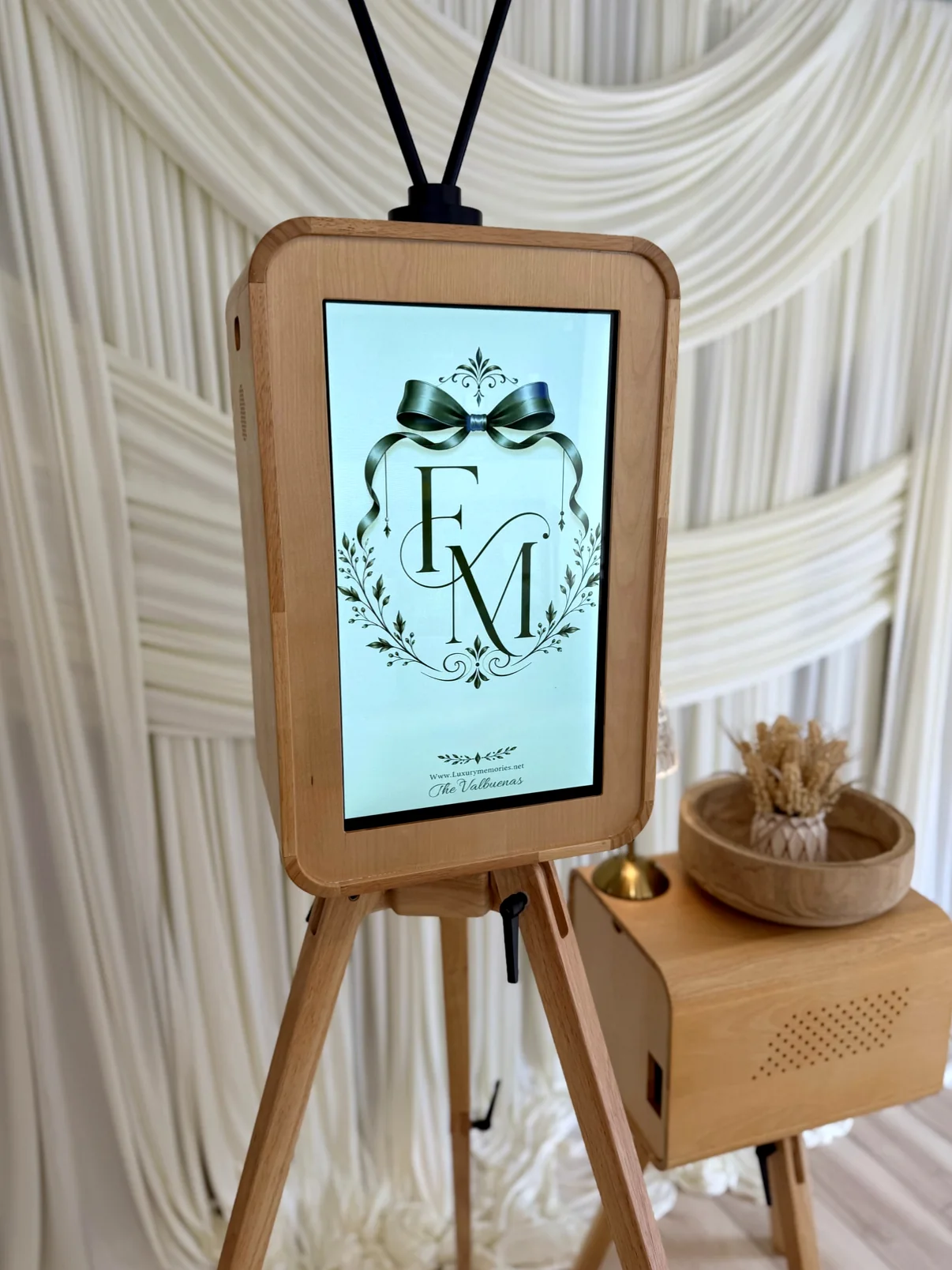 Photo booth in front of ivory drapery