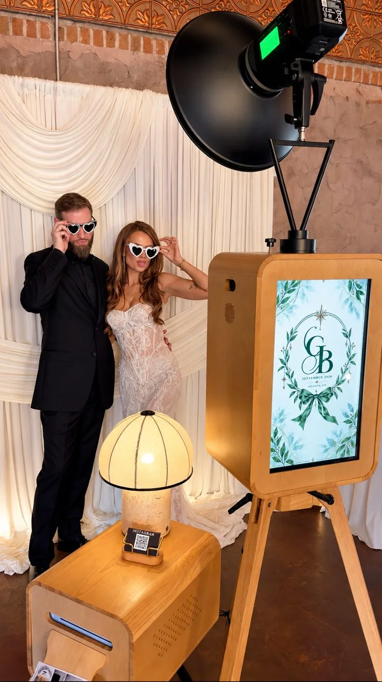 The Luxury Memories DSLR booth with studio beauty-dish lighting and a custom monogram welcome screen