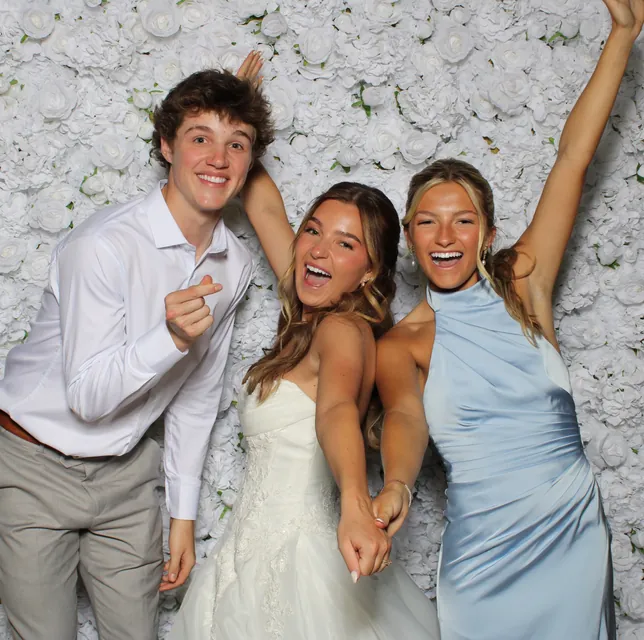 Guests at the white rose flower wall