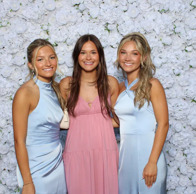 Guests at the white rose flower wall