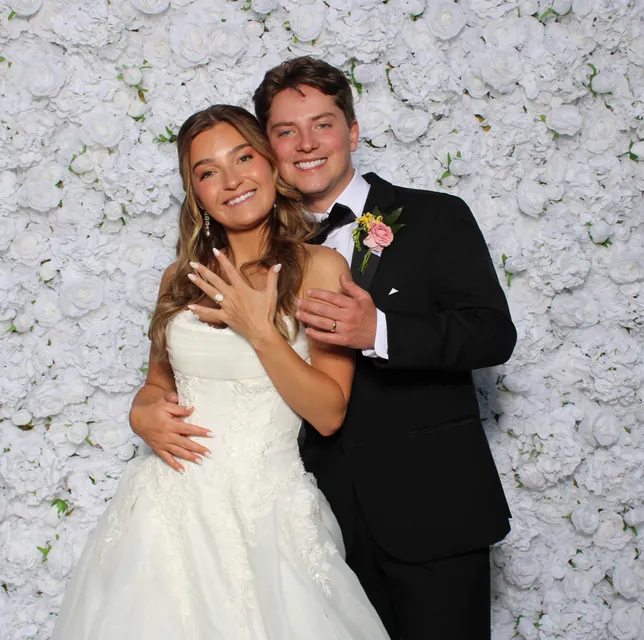 Guests at the white rose flower wall