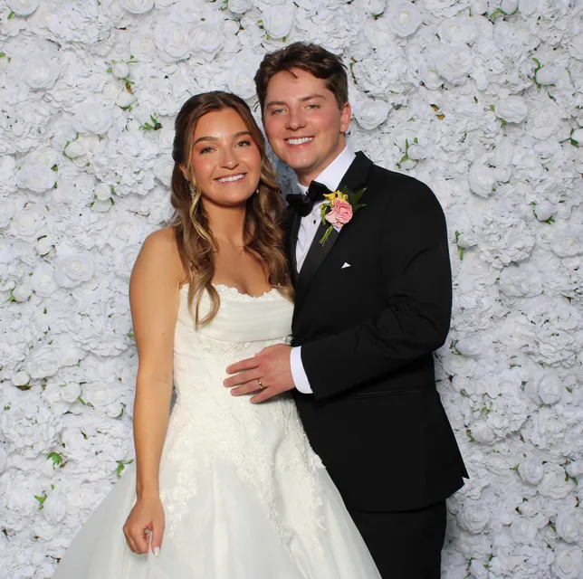 Guests at the white rose flower wall