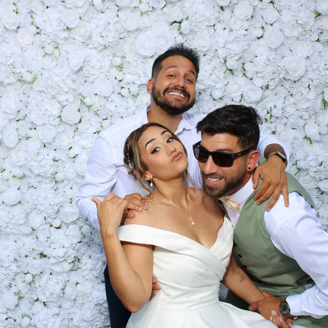 The Valbuenas wedding guests at the white flower wall