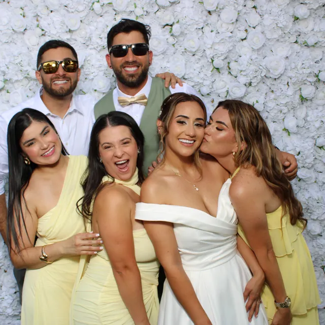 The Valbuenas wedding guests at the white flower wall
