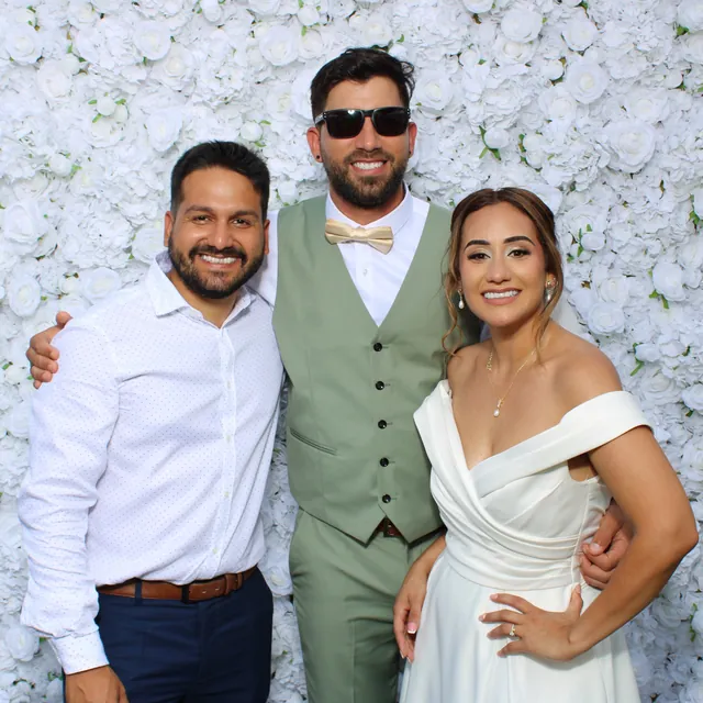 The Valbuenas wedding guests at the white flower wall