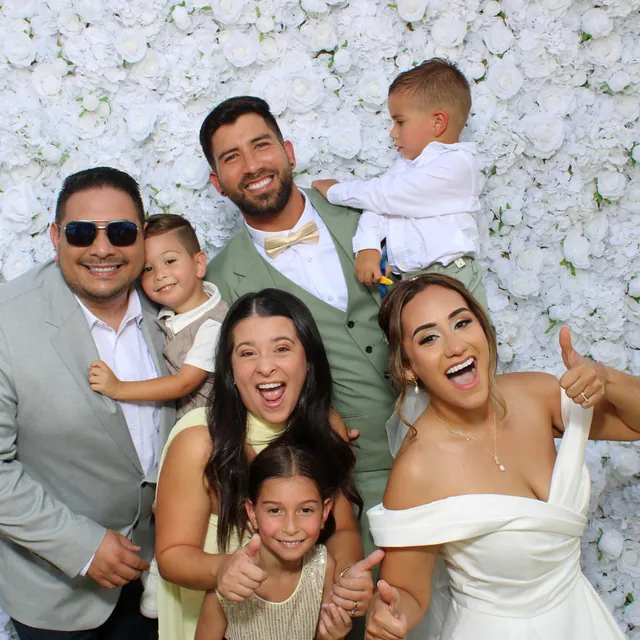 The Valbuenas wedding guests at the white flower wall