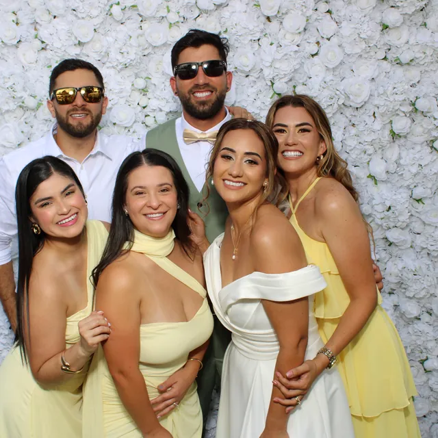 The Valbuenas wedding guests at the white flower wall