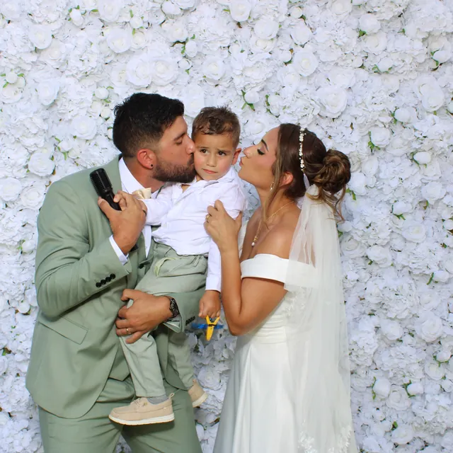 The Valbuenas wedding guests at the white flower wall