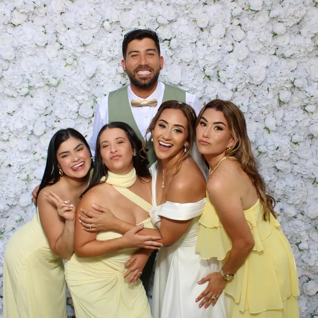 The Valbuenas wedding guests at the white flower wall