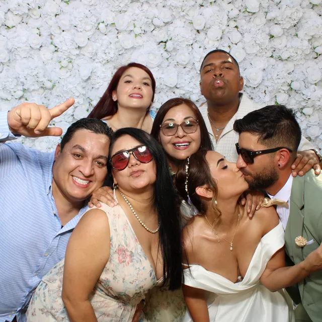 The Valbuenas wedding guests at the white flower wall