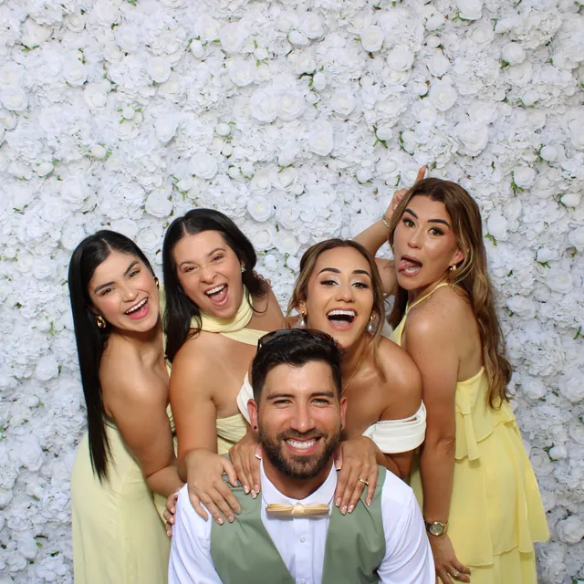The Valbuenas wedding guests at the white flower wall